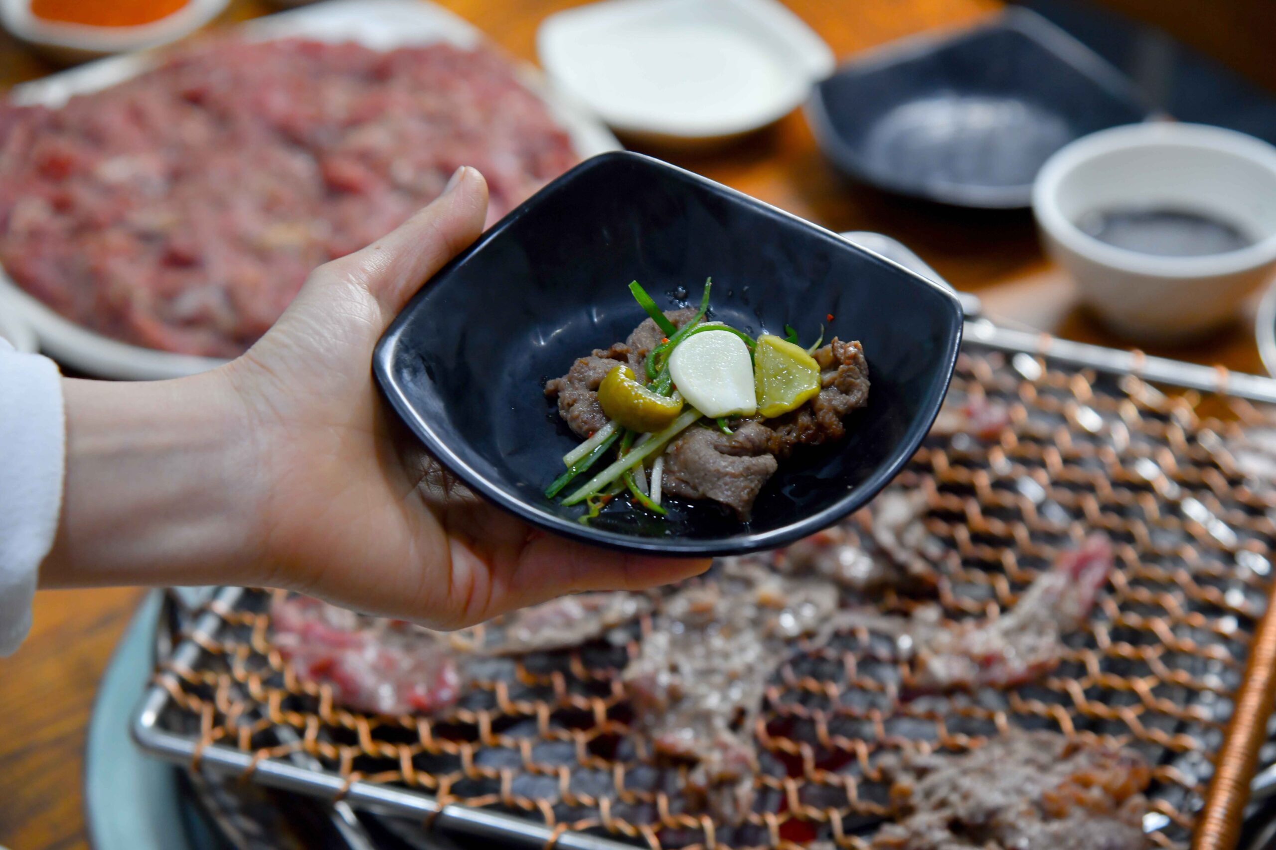 Grilled marinated beef bulgogi served in a shallow pan