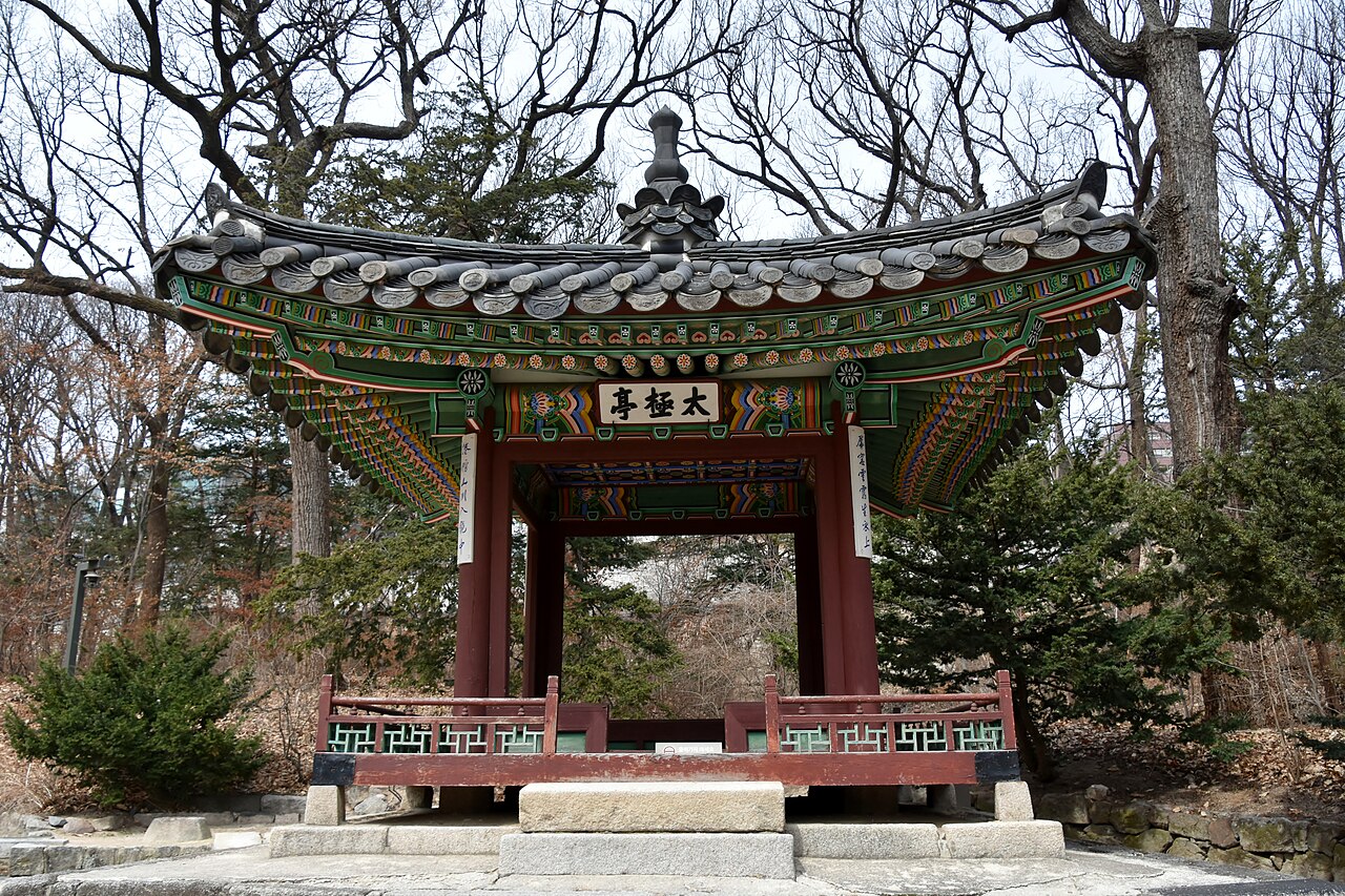 Traditional gate among trees at Changdeokgung Palace in Seoul