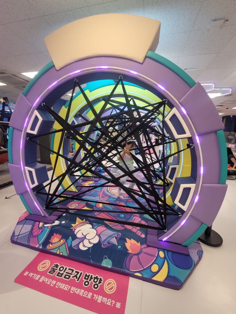 Climbing net play structure inside Monster Park kids cafe at E-mart Susaek, Seoul
