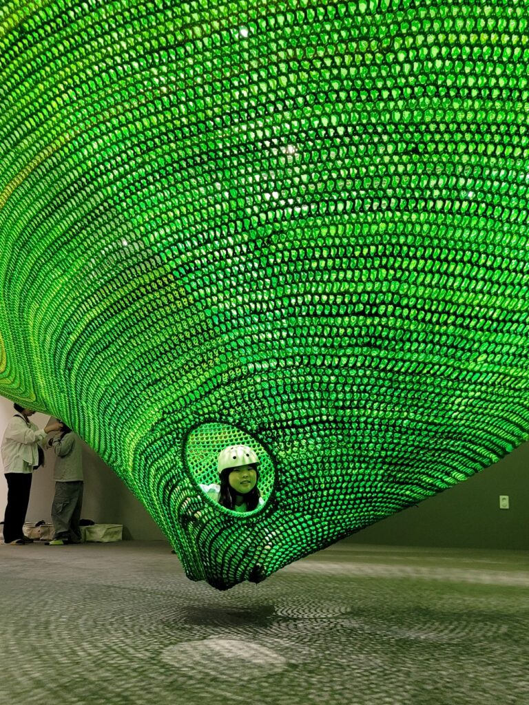 A child climbing the rope net playground at the Seoul Museum of Craft Art Children's Museum